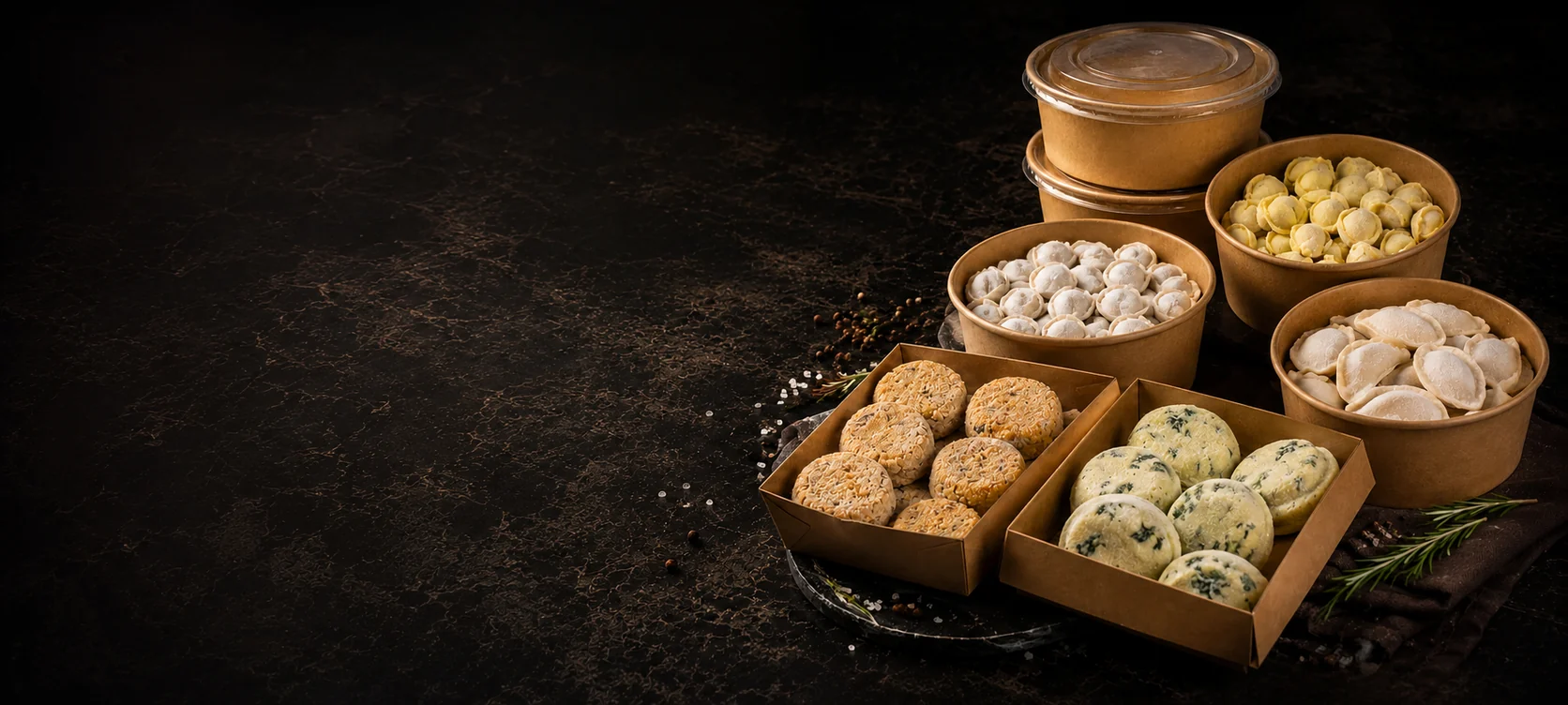 Frozen homemade products in kraft boxes on a dark table