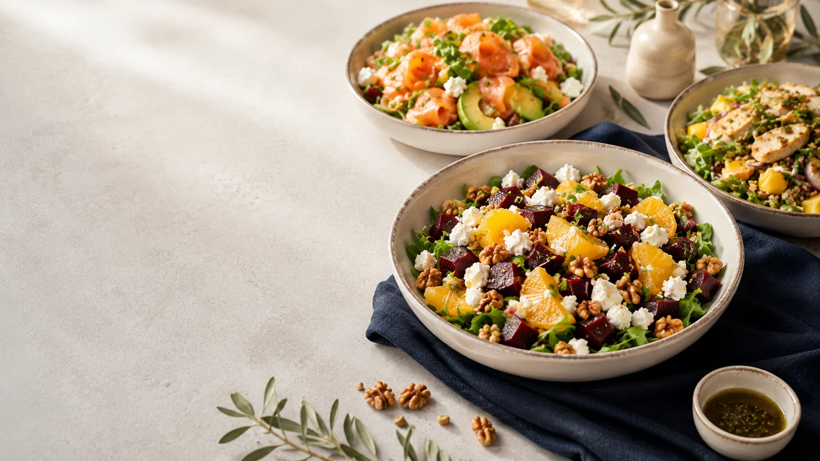 Fresh salads and nourishing bowls on a light stone table